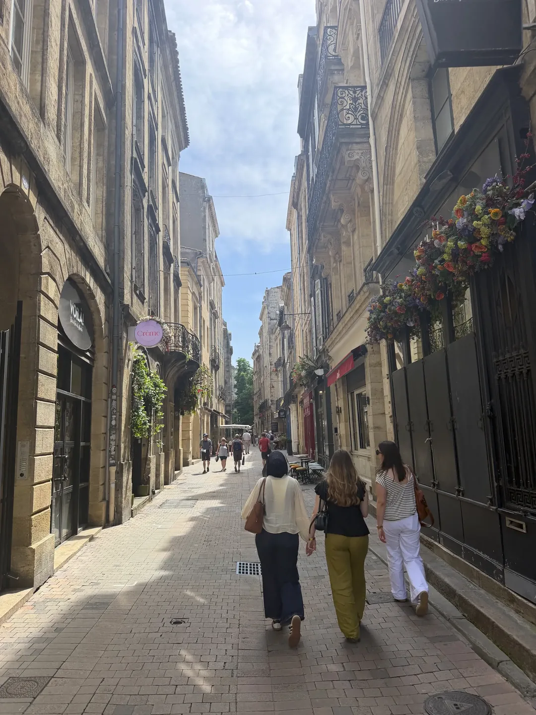 Au pairs walking through the old streets of Bordeaux on their way to a French class